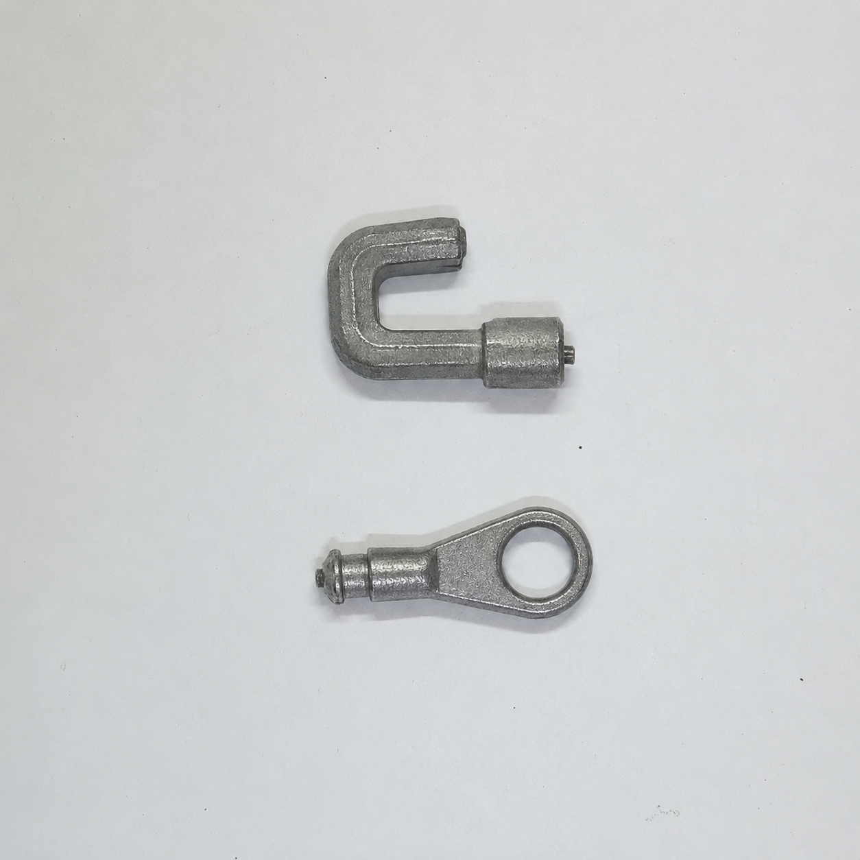 Precision zinc die cast speedometer link components manufactured by SNAA Products for automotive instrumentation systems.